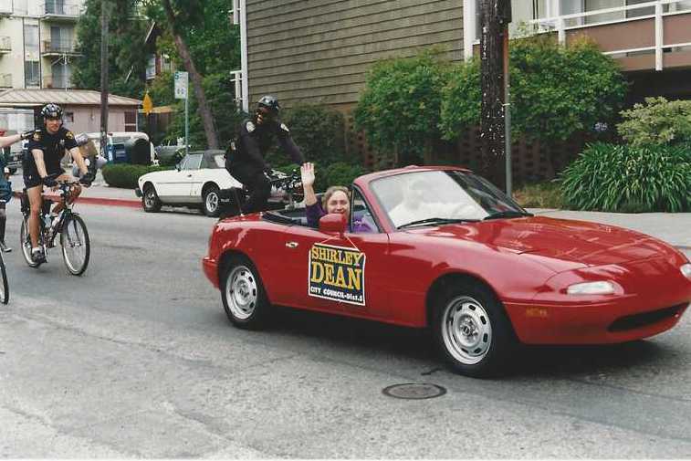 Picture of a car in a parade with Shirley Dean waving